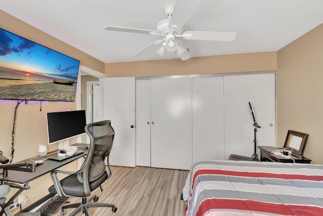 bedroom with ceiling fan and light wood-type flooring