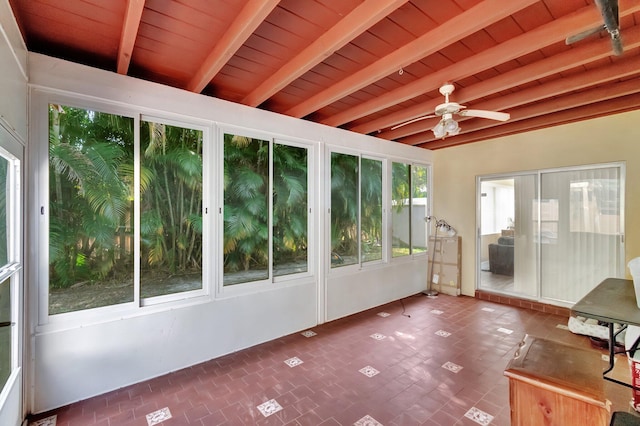 unfurnished sunroom with beamed ceiling, ceiling fan, and wooden ceiling