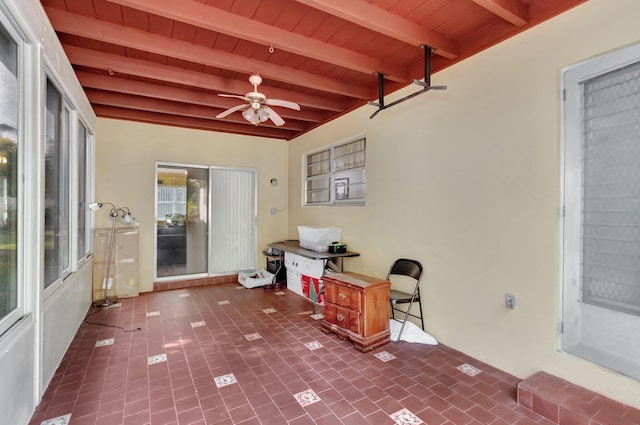 sunroom featuring beamed ceiling, ceiling fan, and wood ceiling