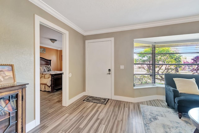 foyer featuring light hardwood / wood-style flooring and ornamental molding