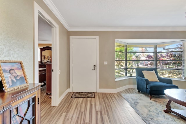 sitting room with crown molding and light hardwood / wood-style flooring