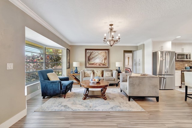 living room featuring a textured ceiling, light hardwood / wood-style flooring, an inviting chandelier, and ornamental molding