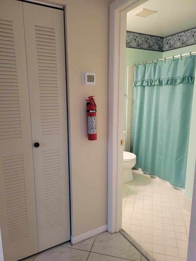 bathroom with tile patterned floors and toilet