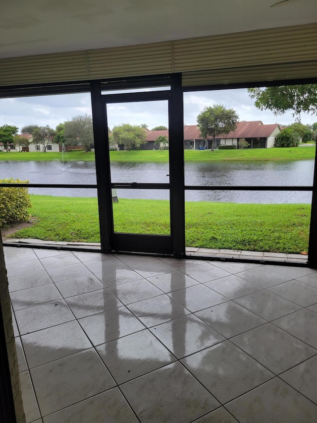 unfurnished sunroom featuring a water view