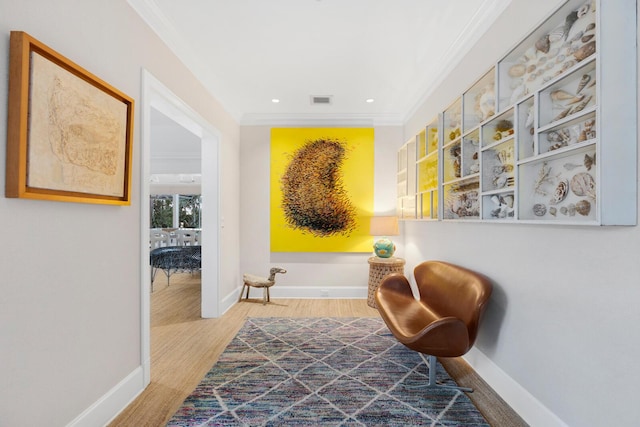 living area featuring ornamental molding and wood-type flooring