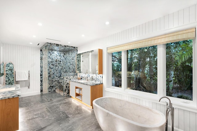 bathroom with vanity and independent shower and bath