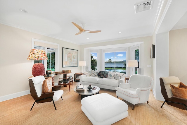 living room featuring plenty of natural light, ceiling fan, and ornamental molding