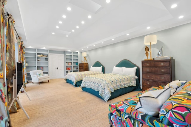 carpeted bedroom featuring a raised ceiling