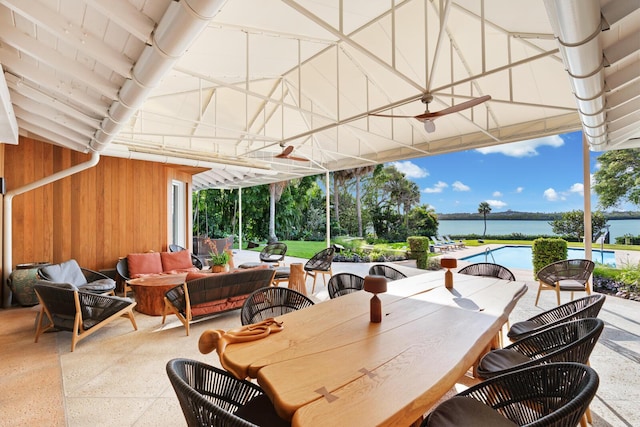 view of patio / terrace featuring an outdoor hangout area, a water view, and a swimming pool