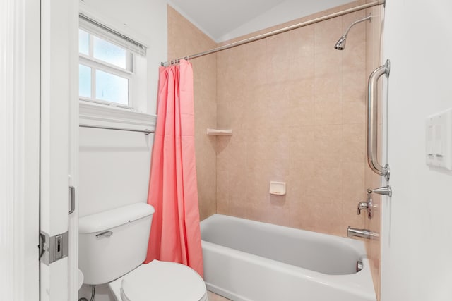 bathroom with shower / bath combination with curtain, vaulted ceiling, and toilet