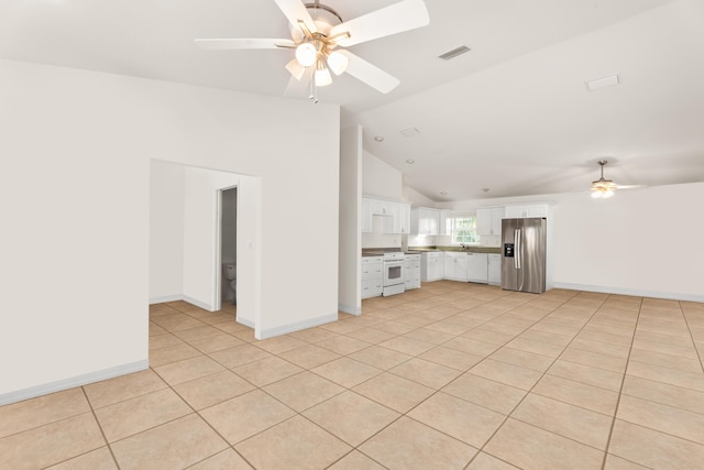 unfurnished living room with ceiling fan, lofted ceiling, and light tile patterned floors