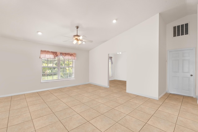 tiled spare room with ceiling fan and vaulted ceiling