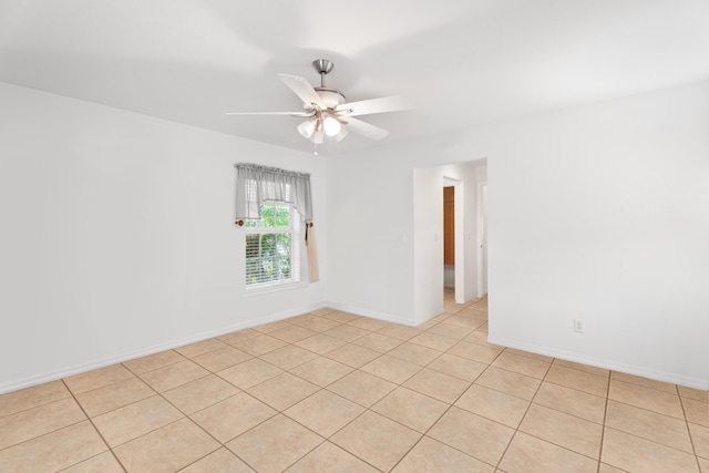 unfurnished room with ceiling fan and light tile patterned flooring