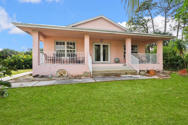 bungalow with french doors, a porch, and a front lawn