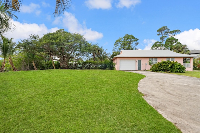 view of front of house with a garage and a front lawn