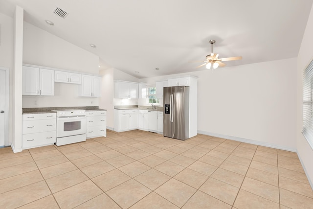 kitchen with white cabinets, range, vaulted ceiling, and stainless steel fridge with ice dispenser