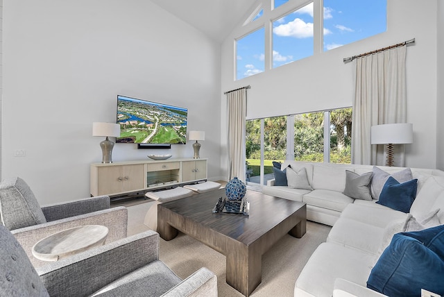 living room with high vaulted ceiling and plenty of natural light