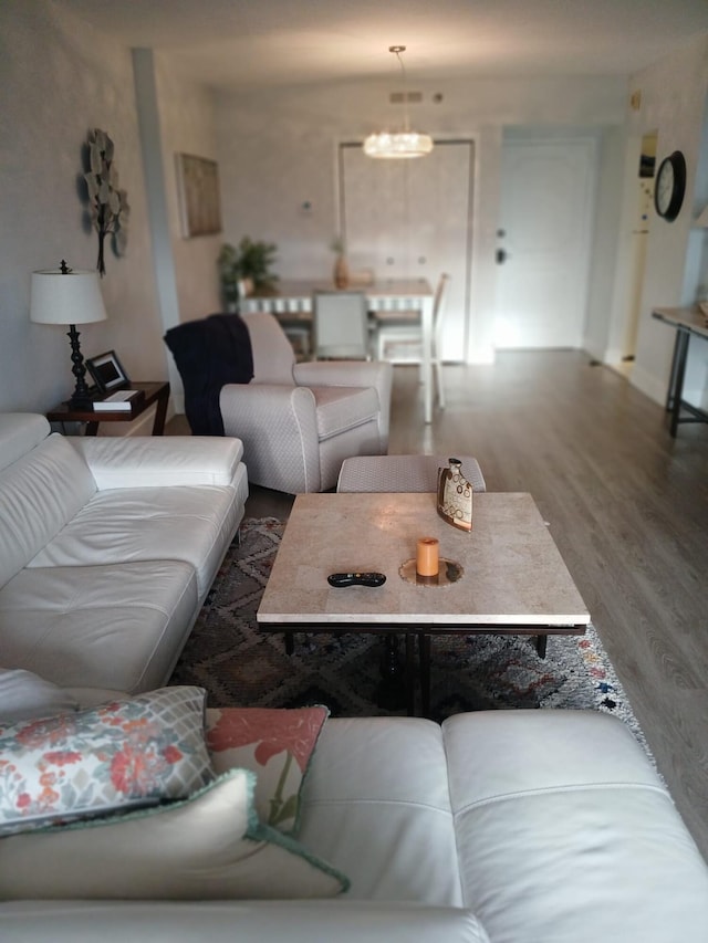 living room featuring hardwood / wood-style floors and a notable chandelier