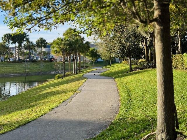 view of community with a lawn and a water view