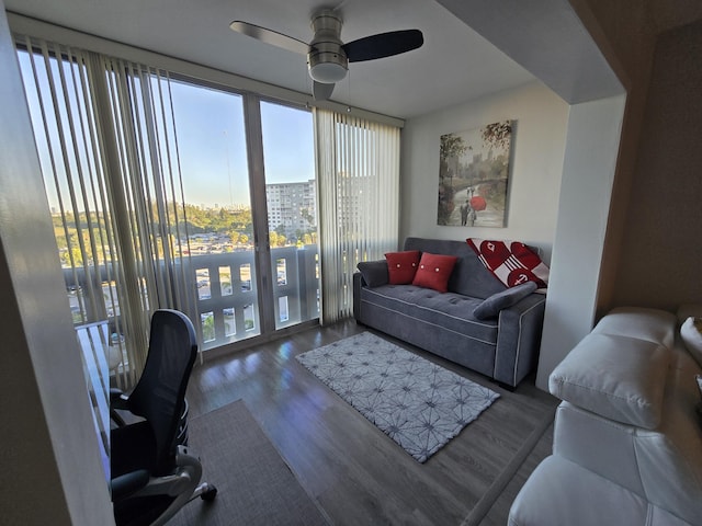 living room featuring expansive windows, a view of city, a ceiling fan, and wood finished floors