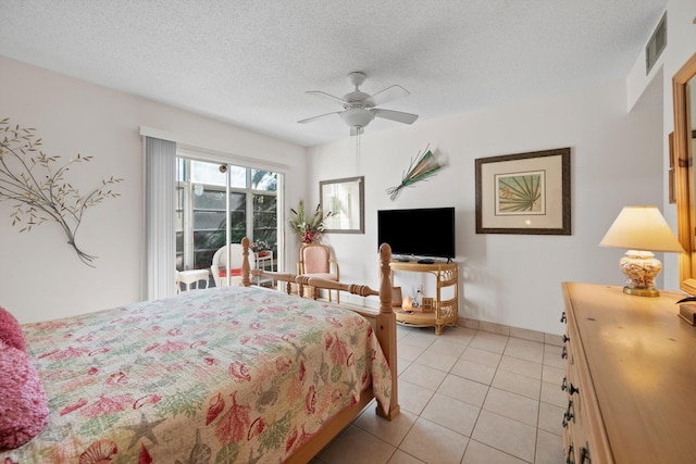 bedroom featuring light tile patterned floors, a textured ceiling, and ceiling fan