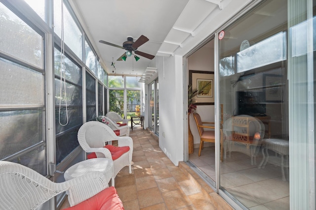 sunroom / solarium featuring ceiling fan