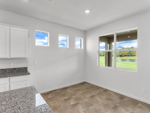 unfurnished dining area featuring a wealth of natural light