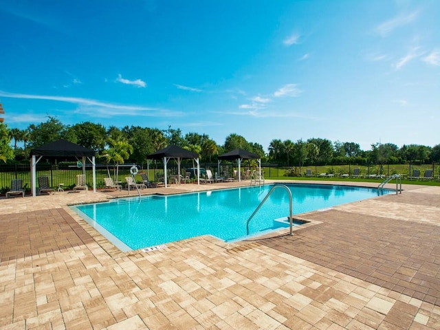 view of swimming pool with a gazebo and a patio