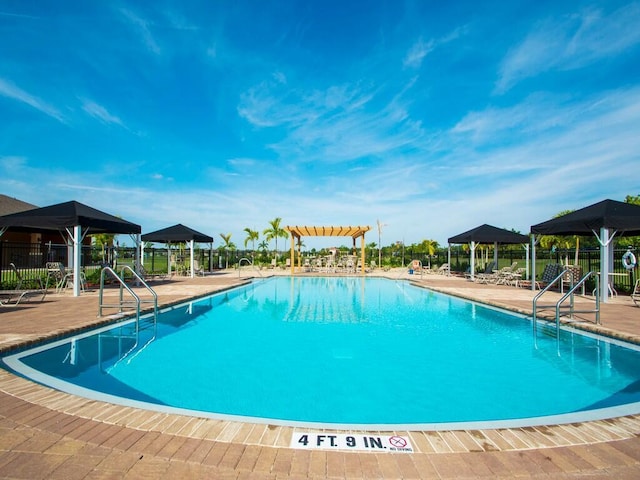 view of swimming pool with a gazebo and a patio area