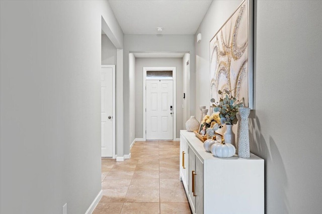 hall featuring light tile patterned floors