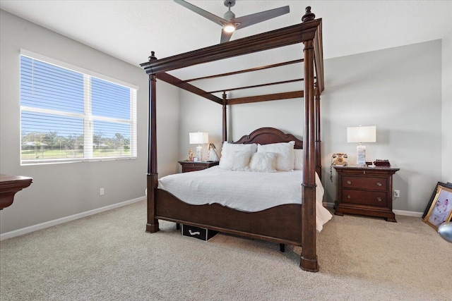 bedroom featuring ceiling fan, light colored carpet, and beam ceiling