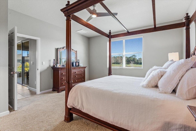 carpeted bedroom with beamed ceiling, ceiling fan, and a textured ceiling