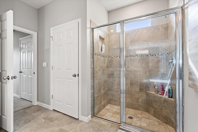 bathroom featuring a shower with shower door