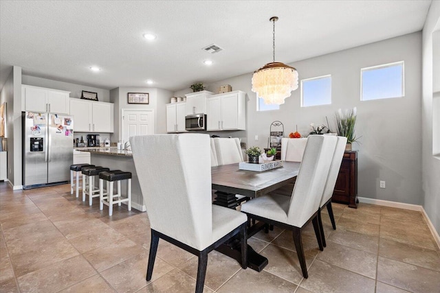 dining area with an inviting chandelier