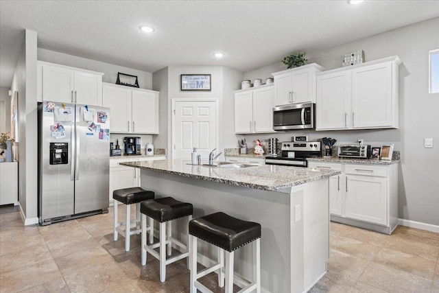 kitchen with white cabinetry, appliances with stainless steel finishes, and sink