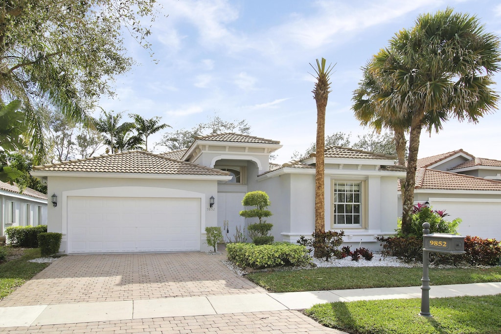 mediterranean / spanish-style house with a garage