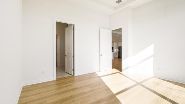 empty room with light hardwood / wood-style flooring