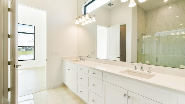 bathroom with a shower with door and vanity