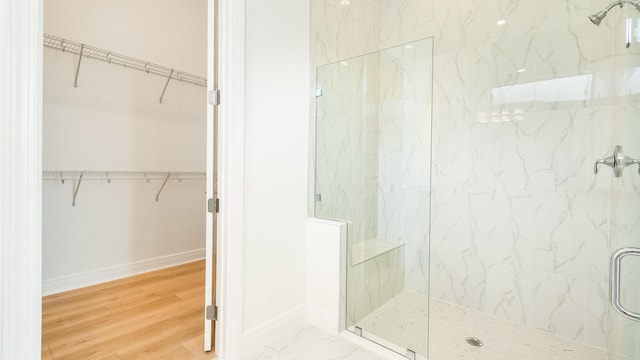 bathroom featuring a shower with shower door