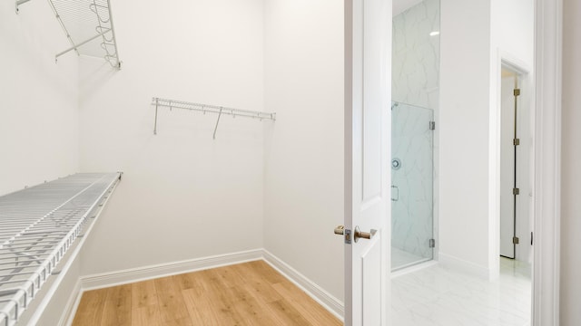 walk in closet featuring light hardwood / wood-style flooring