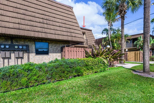 view of side of home featuring a lawn