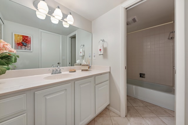 bathroom with tile patterned floors, tiled shower / bath combo, and vanity