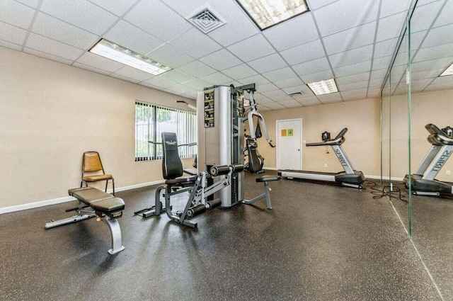 workout area featuring a paneled ceiling