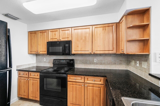 kitchen featuring decorative backsplash, a textured ceiling, dark stone counters, and black appliances