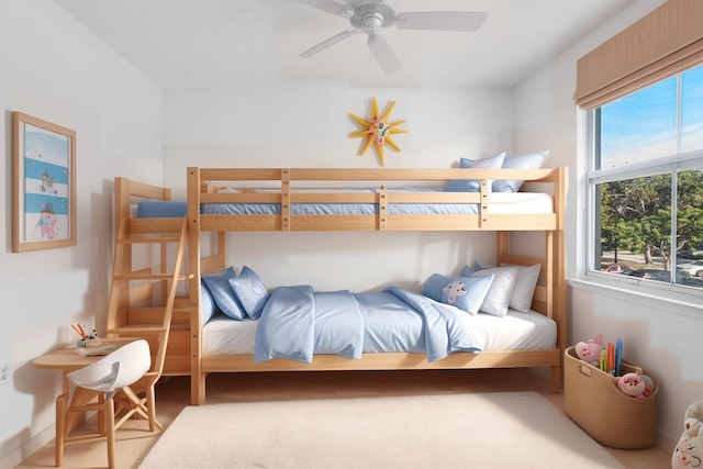 bedroom featuring ceiling fan and multiple windows