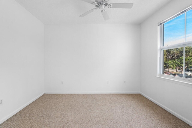 spare room with carpet flooring and ceiling fan