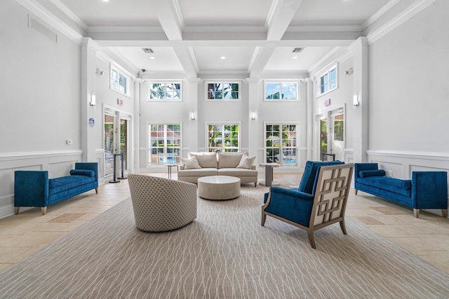 living room featuring beamed ceiling, coffered ceiling, crown molding, and french doors