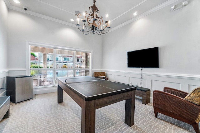 game room with crown molding and an inviting chandelier