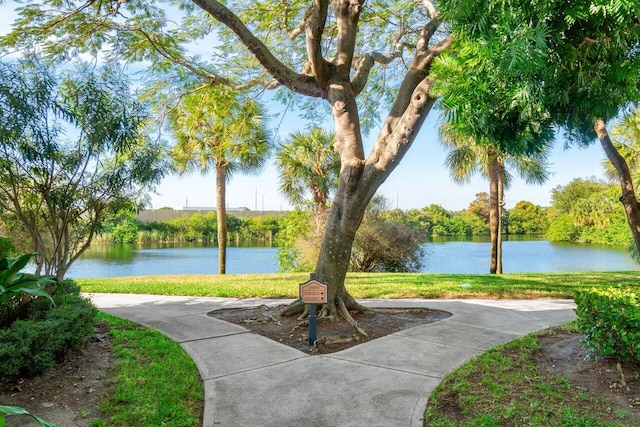 view of property's community with a yard and a water view