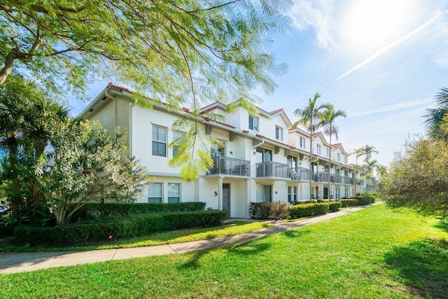 exterior space with a front yard and a balcony